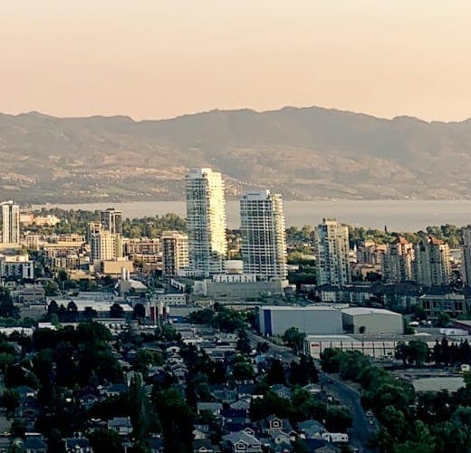 A city on a lake, with hills behind it